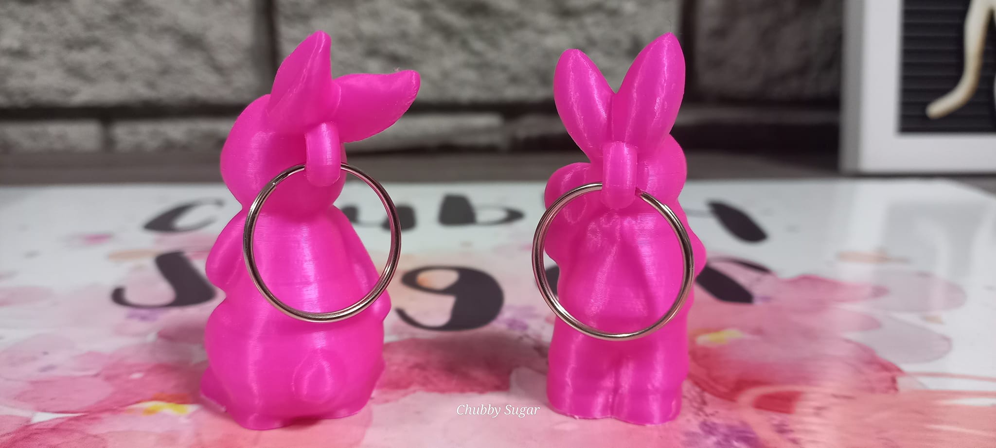 3d-printed rabits holding keychains